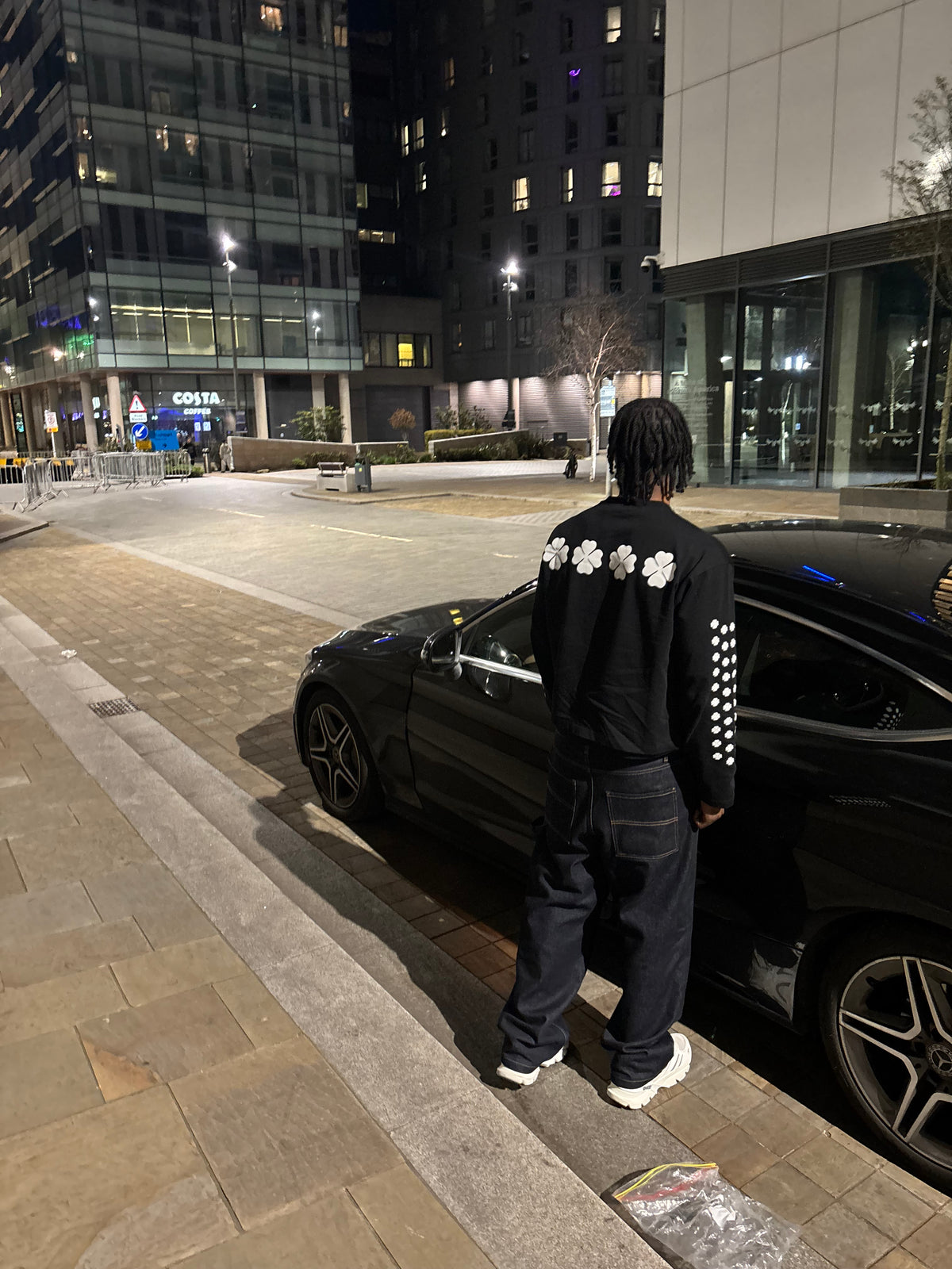 Back of the black Clover longsleeve worn in Manchester at night